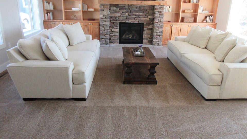 A beautiful living room with tan carpet cleaned by PUIRI.